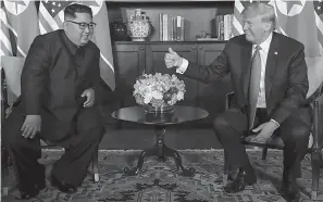  ?? AP Photo/Evan Vucci ?? ■ President Donald Trump gives North Korean leader Kim Jong Un a thumbs up during their meeting Tuesday at a resort on Sentosa Island in Singapore.