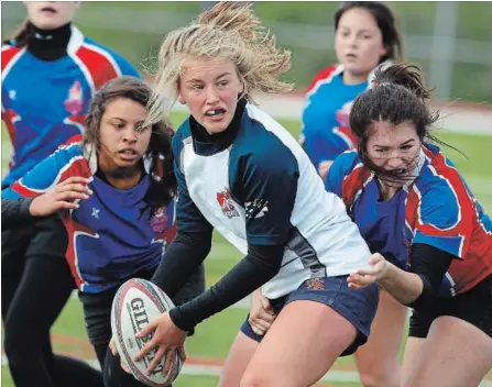  ?? CLIFFORD SKARSTEDT EXAMINER ?? Thomas A. Stewart Griffins’ Lily Stewart attempts to pass the ball against the Cobourg Collegiate Wolves during Kawartha high school senior girls’ rugby AAA playoffs on Oct. 25, 2016, at the Thomas A. Stewart Athletic Field. Stewart is playing for the...