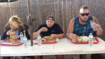  ?? DARLA A. BAKER / TEHACHAPI NEWS ?? From left, Raina Huang had already eaten all of her toppings and was getting started on her Indian Fry Bread as Jake Zwaas and Jake Line continued to plow through their tacos.