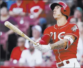  ?? John Minchillo The Associated Press ?? Michael Lorenzen follows through on a pinch-hit grand slam, the second slam by a Reds pitcher in a week, in Cincinnati’s 12-3 victory over the Brewers on Saturday.