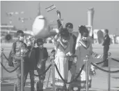  ?? SEBASTIAN SCHEINER/AP ?? Ethiopian immigrants wave Israeli flags as they arrive last year at Ben Gurion Airport near Tel Aviv.