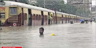  ?? FILE PHOTO ?? A man had to wade through a submerged railway track after three days of non-stop rain in 2005.