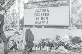  ?? Stephanie Yao Long / The Oregonian via AP ?? Mourners attend a sunset vigil April 17 at the Arts and Communicat­ion Magnet Academy in Beaverton, Ore., in memory of Haruka Weiser, a graduate of ACMA, who was killed in Austin on April 5 while walking on the UT campus.