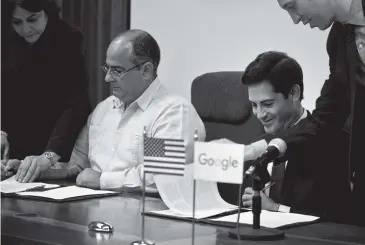  ?? RAMON ESPINOSA AP ?? Luis Adolfo Iglesias Reyes, left, vice president of investment­s for Cuban telecoms monopoly Etecsa, and Google’s head of Cuba operations, Brett Perlmutter, sign a deal in Havana on Thursday. The internet giant and the Cuban government agreed to create a seamless, cost-free connection between their networks when Cuba connects to a new undersea fiber-optic cable.