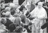  ?? ANDREW MEDICHINI, AP ?? Pope Francis meets with relatives of innocent mafia victims just outside the Vatican on Friday.