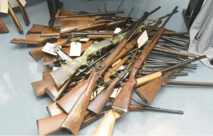  ?? AMY SHORTELL/THE MORNING CALL ?? Guns and ammunition collected during a recent gun buyback event in Northampto­n County are displayed at a news conference Wednesday at the Colonial Regional Police Department in Bethlehem.