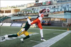  ?? The Canadian Press ?? B.C. Lions Shaq Johnson catches a pass in the end zone, but falls out of bounds as Eskimos’ Monshadrik Hunter defends in Edmonton on Friday night.