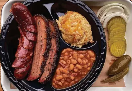  ?? Photos by Mike Sutter / Staff ?? Burnt Bean Co.’s two-meat plates with two sides include choices such as sausage, brisket, bacon ranch potatoes and cowboy beans.