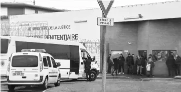  ??  ?? Prison guards block the entrance to the penitentia­ry center of Lille-Annoeullin in Annoeullin, northern France a day after a prison inmate seriously wounded two guards at the penitentia­ry center of Alencon, in Conde-sur-Sarthe, before being detained. — AFP photos