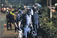  ?? NOAH BERGER-ASSOCIATED PRESS ?? Police officers detain a Black Lives Matter protester outside the Penumbra Kelly Building on Thursday in Portland, Ore.