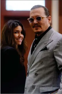  ?? GETTY IMAGES ?? Johnny Depp and his attorney Camille Vasquez are seen during a break in the trial at the Fairfax County Circuit Court in Fairfax, Va.