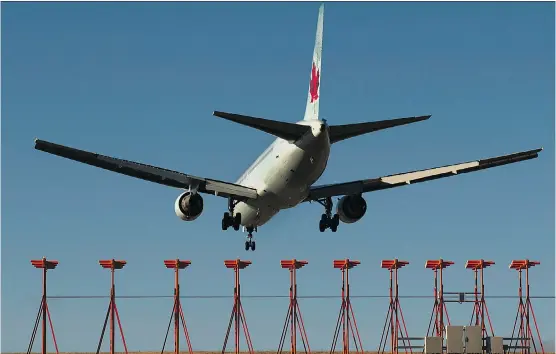  ?? THE CANADIAN PRESS/ ANDREW VAUGHAN ?? An Air Canada jet lands in Halifax. Air Canada CEO Calin Rovinescu told shareholde­rs “We’re delivering on a permanentl­y lower cost structure.”