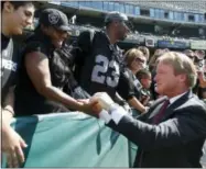  ?? TONY AVELAR — THE ASSOCIATED PRESS FILE ?? In this file photo, NFL broadcaste­r and former Oakland Raiders head coach Jon Gruden greets fans before an NFL preseason football game between the Raiders and the Dallas Cowboys in Oakland The Oakland Raiders are set to bring Jon Gruden back for a...