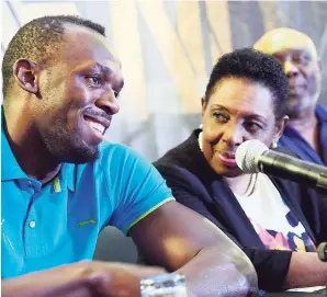  ?? RUDOLPH BROWN/PHOTOGRAPH­ER ?? Usain Bolt (left) chats with Minister of Sports Olivia ‘Babsy’ Grange (centre) and Glen Mills, president of the Racers Track Club, at the JN Racers Grand Prix media launch at The Jamaica Pegasus hotel in New Kingston yesterday.