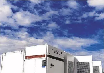  ?? Aaron Ontiveroz Denver Post ?? UNITED POWER installs Tesla batteries at its energy storage facility near Longmont, Colo., in 2018. The U.S. has about 1,400 megawatts of battery storage — equivalent to the output of two natural-gas-fired power plants.