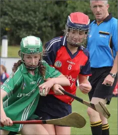  ??  ?? Lisa Murphy (Cloughbawn) holds on to possession despite the close attention of Aoibhe McSweeney (Kilrush).