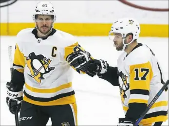  ?? Billy Hurst/Associated Press photos ?? Sidney Crosby, left, scored twice in the Penguins’ 4-1 win against the St. Louis Blues on Sunday in St. Louis, putting him at 401 career goals.