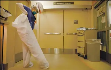  ?? RANDY VAZQUEZ — STAFF PHOTOGRAPH­ER ?? Registered nurse Barbara Callens puts on a protective suit before checking on a patient in the intensive care unit at El Camino Health Mountain View Hospital on Tuesday.