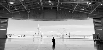  ?? AP ?? Virgin Galactic ground crew guide the company’s carrier plane into the hangar at Spaceport America following a test flight over the desert near Upham, New Mexico, on Thursday, August 15.