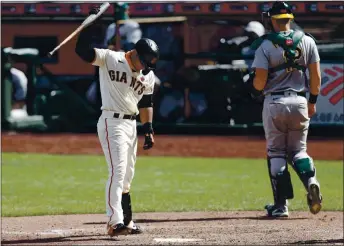  ?? NHAT V. MEYER — STAFF PHOTOGRAPH­ER ?? The Giants’ Donovan Solano reacts to striking out against the Athletics during the seventh inning at Oracle Park on Sunday.