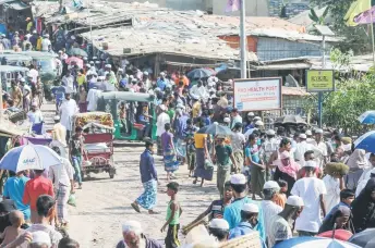  ?? — AFP file photo ?? Rohingya refugees seen gathering at a market in Kutupalong refugee camp in Ukhia, Bangladesh.