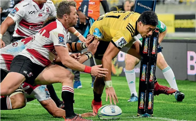  ?? PHOTOSPORT ?? Ben Lam beats three Lions defenders to score in the corner for one of his three tries at Westpac Stadium last night. The big wing has now scored 12 tries in Super Rugby this year.