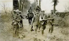  ?? TORONTO STAR FILE PHOTOS ?? CANADIAN AND GERMAN BOYS AT WAR — In 1918, down the tree-lined roads out from Cambrai came the hordes of youth of Germany to look with wonder at the youthful faces of their conquerors. This remarkable photograph is surely one of the bitterest arguments...