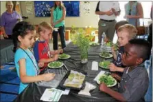  ?? DIGITAL FIRST MEDIA FILE PHOTO ?? A kindergart­en class at Rupert Elementary School in Pottstown eat a salad of healthy greens they made using an indoor tower garden. As children age, their nutritiona­l needs change.