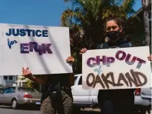  ?? Jungho Kim / Special to The Chronicle ?? Residents oppose the California Highway Patrol on Oakland streets. CHP officers shot and killed Erik Salgado last June.