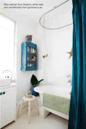  ?? Blue cabinet from Amatuli; white stool and candlehold­er from gumtree.co.za ?? Wooden pieces bring warmth to the bathroom and pops of jewel-toned blue, including the shower curtain Abi made from fabric she found in India, add interest.