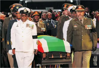  ?? AP PHOTO/FELIX DLANGAMAND­LA, POOL ?? Former South African president Nelson Mandela’s casket is led by military pallbearer­s following the service at his state funeral Sunday in Qunu, South Africa. More than 4,500 mourners, including royalty, political leaders and celebritie­s, turned out to...