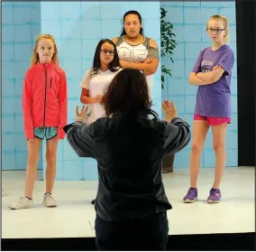  ?? FILE PHOTO/ANDY SHUPE ?? Instructor Jules Taylor (center) works with actors Viola Kelley, Violet Newberry, Kayla Henderson and Ayla Fortin during a Broadway Bound Theater camp at Arts Live Theatre. Summer camps begin June 5 at the Fayettevil­le youth theater company.