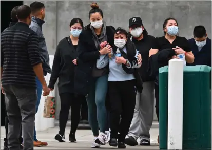  ?? PHOTOS BY JOSE CARLOS FAJARDO — STAFF PHOTOGRAPH­ER ?? Family members of fallen Oakland Police Officer Tuan Le depart Highland Hospital in Oakland on Friday. The officer, who had been on the force for four years, was shot early Friday in the area of Embarcader­o and Fifth Avenue after responding to a report of a burglary.