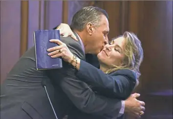  ??  ?? Councilman Anthony Coghill kisses longtime partner Lisa Orlando after taking the oath of office Wednesday during inaugurati­on ceremonies at the City-County Building.