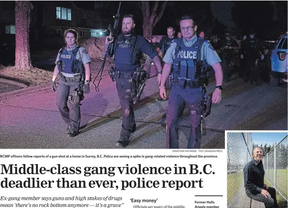  ?? JONATHAN HAYWARD THE CANADIAN PRESS ?? RCMP officers follow reports of a gun shot at a home in Surrey, B.C. Police are seeing a spike in gang-related violence throughout the province.