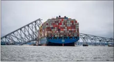  ?? JERRY JACKSON — BALTIMORE SUN ?? The container ship Dali is seen in the wreckage of Francis Scott Key Bridge on Monday, almost a week after it hit a structural pier causing a bridge collapse in Baltimore.