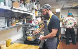  ??  ?? Stayer prepares Nonno’s Pasta in the kitchen at Nobie’s. The dish is tagliatell­e with a Bolognese sauce inspired by the chef’s father-in-law.