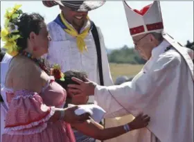  ?? ALESSANDRA TARANTINO — THE ASSOCIATED PRESS ?? A child reaches out to embrace Pope Francis Jan. 17 in the offertory of a Mass at the Maquehue Air Base, in Temuco, Chile. Francis is paying homage to Chileans who were tortured or killed at the air base.