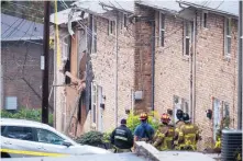  ?? DAVID GOLDMAN/ASSOCIATED PRESS ?? Firefighte­rs respond to the scene where an airplane crashed into a townhome Wednesday in the Atlanta area. The FAA said the wreck occurred soon after takeoff.