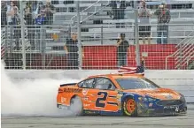  ?? THE ASSOCIATED PRESS ?? Brad Keselowski passes the grandstand after winning Sunday at Atlanta Motor Speedway. It’s his first NASCAR Cup Series victory there.