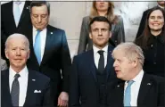  ?? THIBAULT CAMUS — THE ASSOCIATED PRESS ?? President Joe Biden and British Prime Minister Boris Johnson, front right, during a group photo during the NATO summit in Brussels on Thursday. Biden and Western allies aim to ramp up pressure on Russian President Vladimir Putin while tending to his invasion’s economic and security fallout.