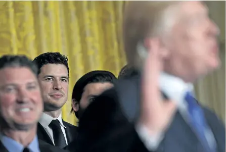  ?? SUSAN WALSH/THE ASSOCIATED PRESS ?? Penguins’ captain Sidney Crosby, third from left, listens as U.S. President Donald Trump, right, speaks about the 2017 NHL Stanley Cup Champion Pittsburgh Penguins, on Tuesday, during a ceremony in the East Room of the White House, in Washington.