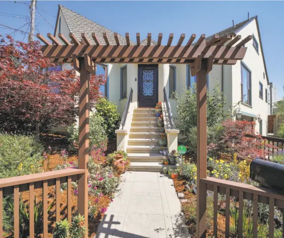  ?? OPEN HOMES PHOTOGRAPH­Y ?? Vibrant gardens line a walkway leading to the front door of the Albany home.