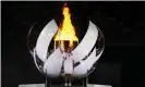  ??  ?? Japan’s Naomi Osaka lights the cauldron during the opening ceremony of the Games. Photograph: Natacha Pisarenko/AP