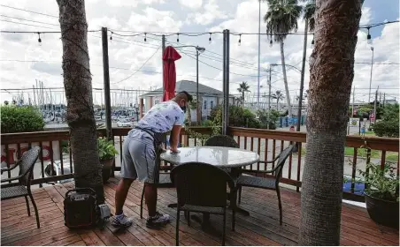  ?? Yi-Chin Lee / Staff file photo ?? Nam Thai Restaurant & Bar owner Skyy Rivera cleans tables at the restaurant in August. Food workers have been hit especially hard.