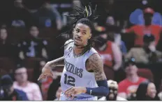  ?? MICHAEL WYKE/AP ?? MEMPHIS GRIZZLIES GUARD JA MORANT reacts after sinking a three point shot against the Houston Rockets during the first half of a game on March 1 in Houston.