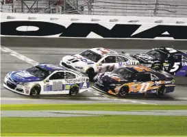  ?? TERRY RENNA/ASSOCIATED PRESS ?? Denny Hamlin (11) eventually slips past Dale Earnhardt Jr. (88) to win the second qualifier.