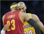  ?? PAUL RODRIGUEZ — THE ORANGE COUNTY REGISTER VIA AP, FILE ?? In this file photo, Los Angeles Lakers guard Kobe Bryant, right, and Cleveland Cavaliers forward LeBron James hug before the start of an NBA basketball game, in Los Angeles. The Los Angeles Lakers have a new superstar ‘Ä’ L.A.-Bron. The four-time NBA...