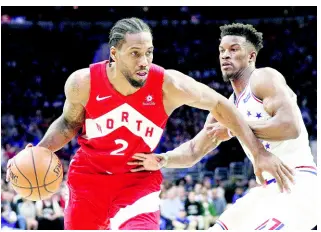  ?? AP ?? Toronto Raptors’ Kawhi Leonard (left) drives against Philadelph­ia 76ers’ Jimmy Butler during the second half of Game Four of a second-round NBA play-off series in Philadelph­ia yesterday. The Raptors won 101-96.