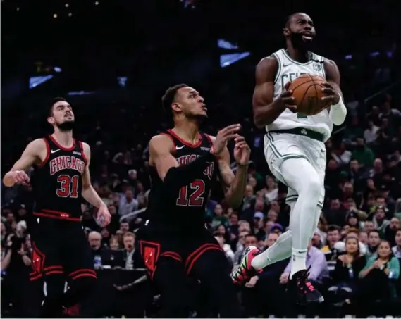  ?? (AP) ?? BOSTON TCeltics guard Jaylen Brown (7) outruns Chicago Bulls guard Tomas Satoransky (31) and forward Daniel Gafford (12) on a drive to the basket during the first half of an NBA basketball game in Boston, Monday, Jan. 13, 2020.